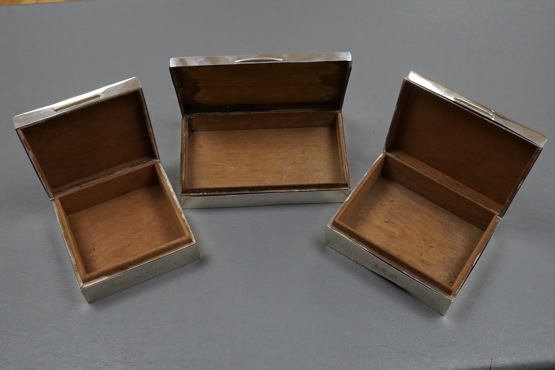 Three assorted silver mounted cigarette boxes, the largest by Frederick William Hentsch, London, 1924, 14.3cm.